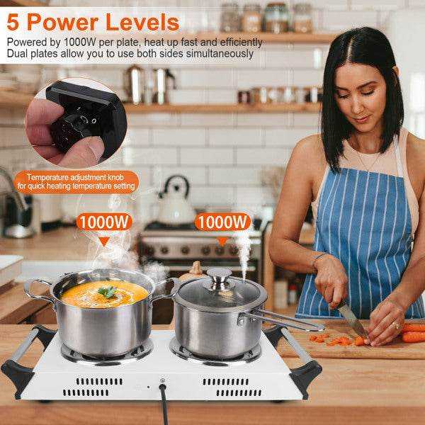 Woman adjusting temperature on dual burner electric stove with cooking pots