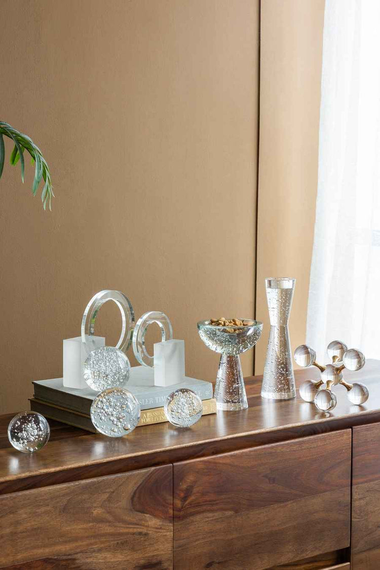 Decorative items on a wooden surface with a neutral background