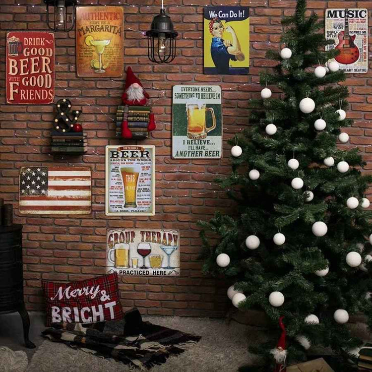 Decorated Christmas tree with white ornaments in a room with brick walls and various beer-themed signs.