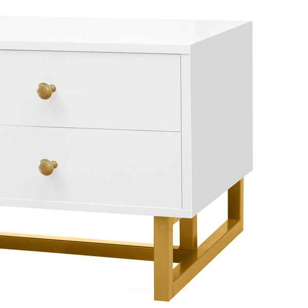 White nightstand with gold legs and drawers on a white background
