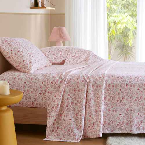 Twin XL Cotton Flannel Sheet Set in Holiday Doodles print displayed on a bed, ideal for festive dorm room bedding and winter comfort.