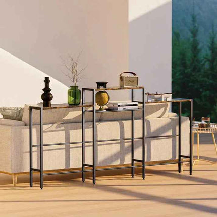 Modern console tables behind beige sofa in sunlit living room with decorative accents.