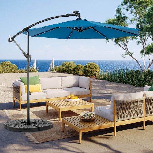 Outdoor patio with blue cantilever umbrella, modern sofa set, wooden tables, ocean view