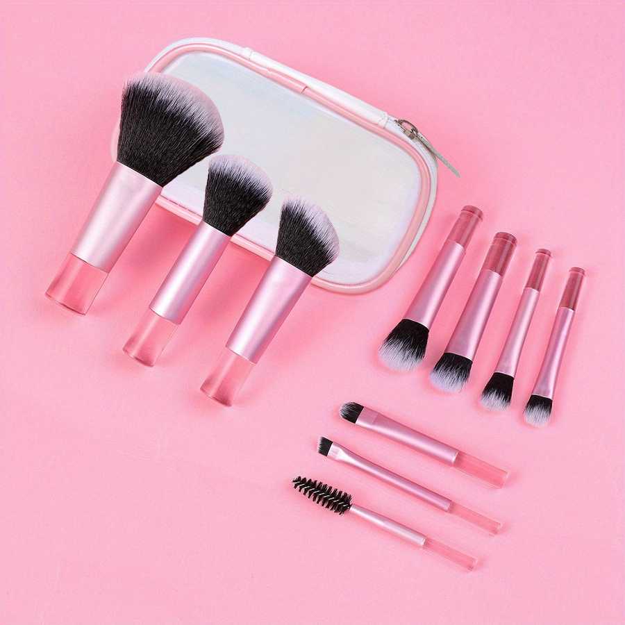 Durable 10-piece mini makeup brush set with pink handles and clear zip pouch. Designed for precise makeup application and easy portability.