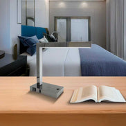 LED Desk Lamp with USB and Power Outlet - Modern Table Lamp on wooden desk in a contemporary bedroom, ideal for home or hotel use.