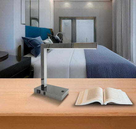 LED Desk Lamp with USB and Power Outlet - Modern Table Lamp on wooden desk in a contemporary bedroom, ideal for home or hotel use.