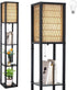 A tall black metal floor lamp with a woven beige shade and pull-chain switch, shown in two views on a white background. One view shows the lamp styled with books and a small plant on its shelves, and a light bulb icon appears in the top right corner.