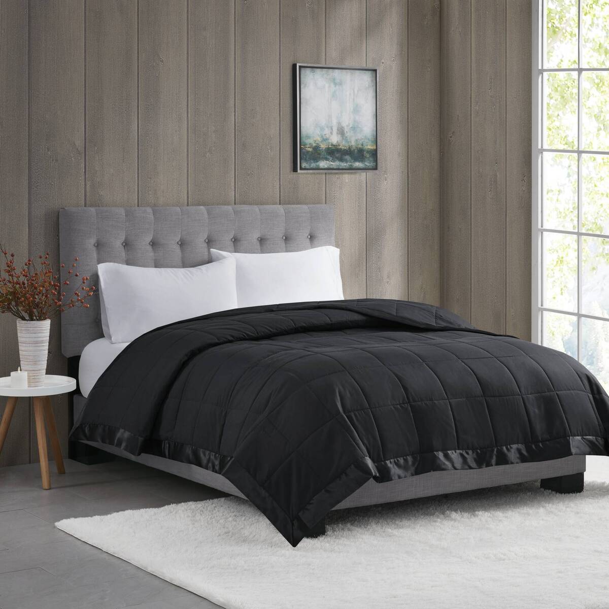 Lightweight Down Alternative Blanket in black twin size on a modern bed with gray headboard, ideal for stylish and cozy bedding upgrades.