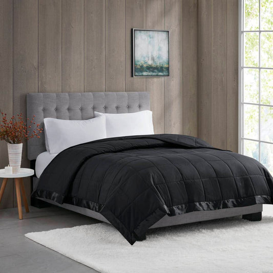 Lightweight Down Alternative Blanket in black twin size on a modern bed with gray headboard, ideal for stylish and cozy bedding upgrades.