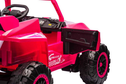 Close-up of pink ride-on toy car interior with steering wheel