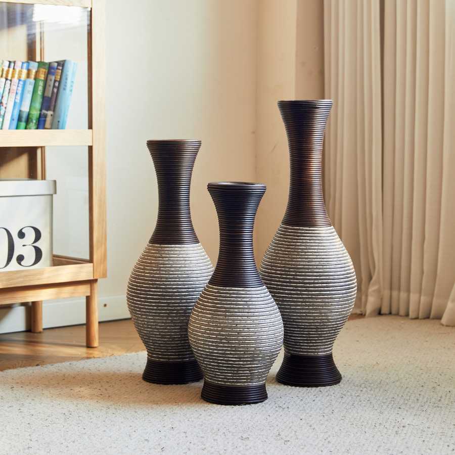 Elegant brown floor vase set of 3 placed in a cozy living room corner, perfect for showcasing decorative branches or flowers.