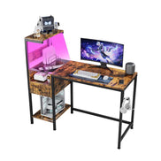 Computer desk with LED lighting and reversible shelves, featuring monitor, keyboard, and organized accessories for home office use.