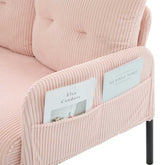 Pink corduroy chair with magazine holder containing books.