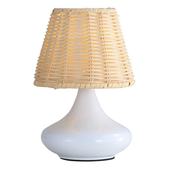 Table lamp with a wicker shade on a white background