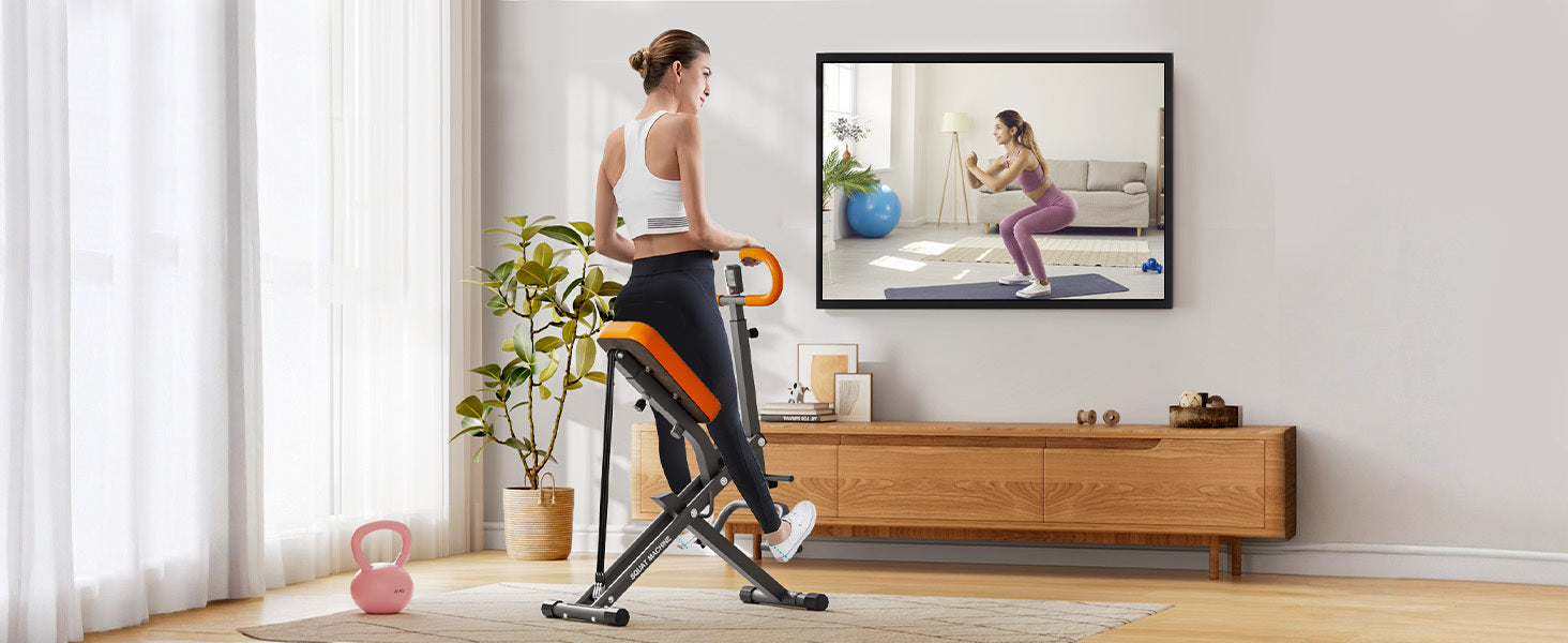 User exercising on Squat Machine Home while watching a virtual trainer, ideal for compact home fitness routines.