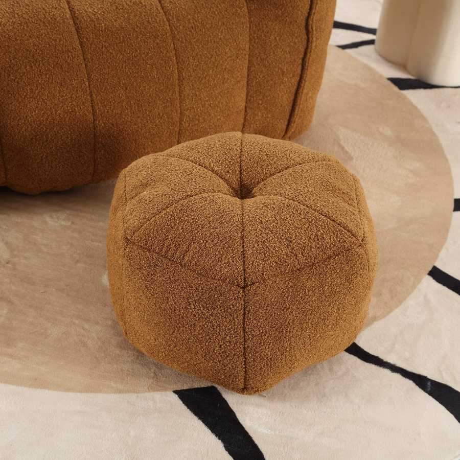 Brown textured ottoman on a patterned rug