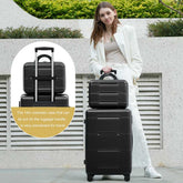 Woman holding a black suitcase with a smaller cosmetic case on top, outdoor setting.