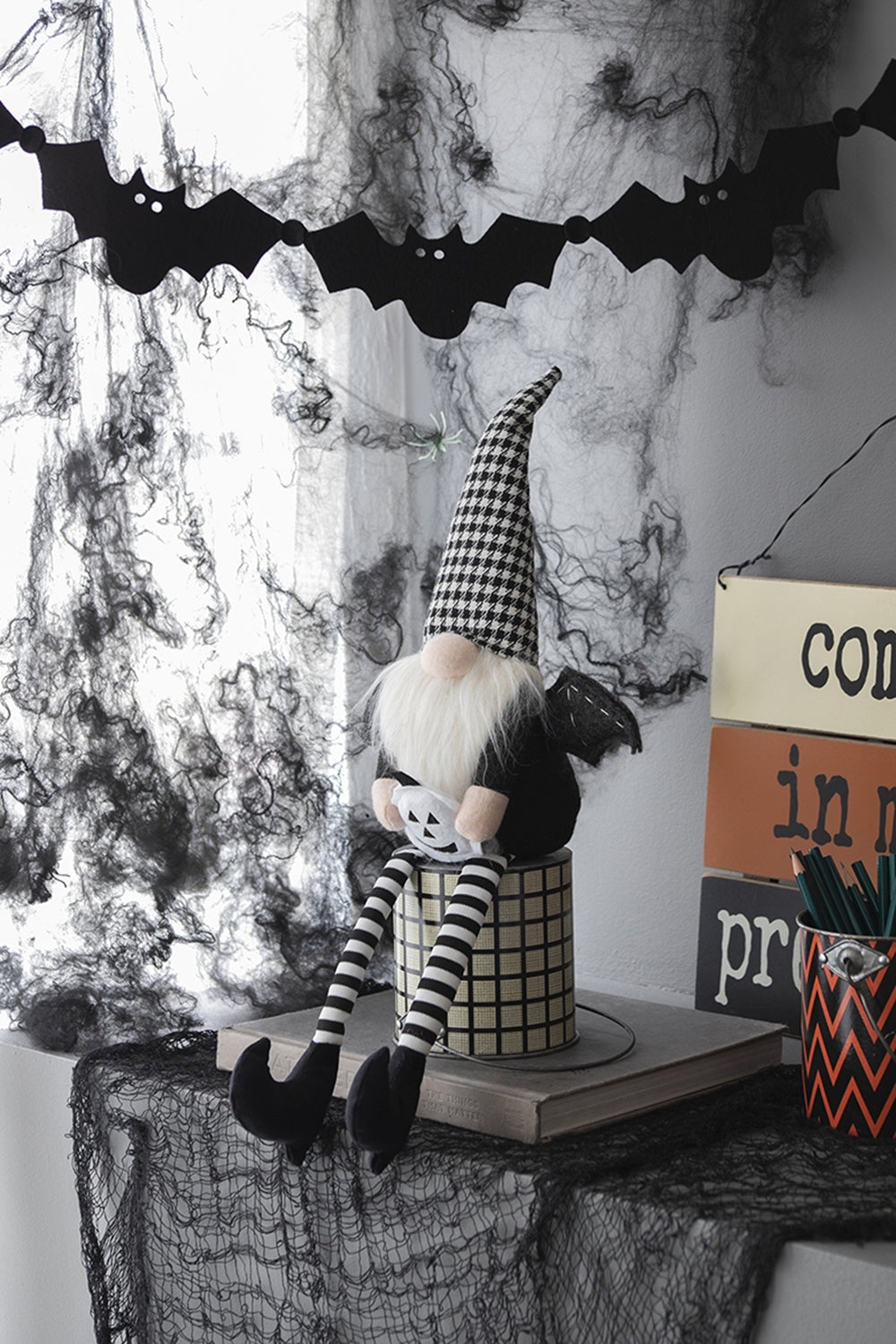 Halloween-themed decor with a gnome, bats, and a &