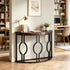 A curved console table with a dark wood top and black metal frame featuring three large interlocking oval motifs, styled in a home office setting.