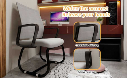 Office chair with armrest widening feature in a room setting
