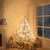 Decorated Christmas tree with lights in a room with a window showing snowy outdoors.