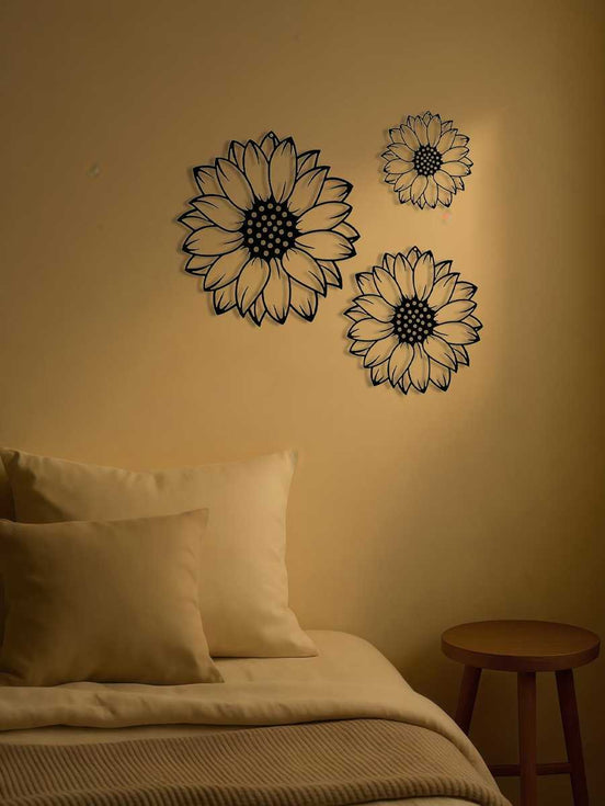 Set of 3 elegant metal sunflower wall art pieces above a cozy bed. Ideal for enhancing bedroom ambiance with unique floral metal decor.
