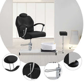 Black salon chair with sink and mirror in a salon setting