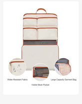 Interior of a large capacity garment bag in white with orange trim, showing multiple compartments, mesh pockets, and organizational features.