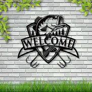 Black fish wall decor with trees and 'Welcome' banner on white siding