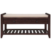 A dark brown wooden bench with a beige cushioned seat, featuring two drawers with round dark knobs and a slatted lower shelf, shown against a plain white background.