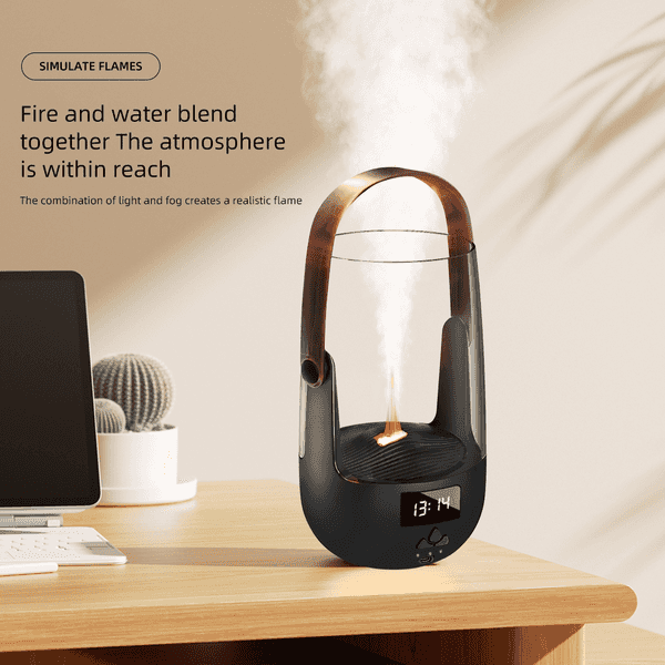 A modern tabletop humidifier and diffuser sits on a wooden desk in a styled home office setting. The device has a matte black base, a transparent glass body, a copper-colored metal handle, and a digital display showing 13:14.