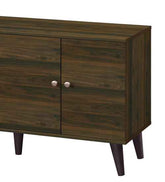 Close-up of the dark wood finish and rounded metal knobs on the cabinet doors of the modern TV stand with angled legs.