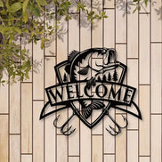 Black fish wall decor with trees and 'Welcome' banner on white brick wall