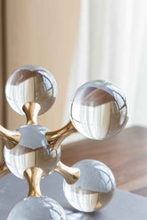 Decorative object with metallic finish on a neutral background