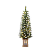 Decorative Christmas tree with lights in a wooden planter on a white background