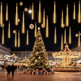 Meteor shower lights hanging above a Christmas market with a tree and carousel