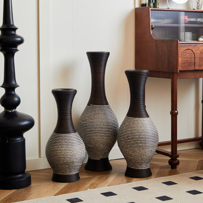 Modern brown floor vase set of 3 with tall, curved design, perfect for home décor, shown near a black lamp and wooden writing desk.