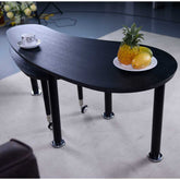Close-up of 360 Rotatable Coffee Table with tropical fruit, showcasing its smooth black finish and functional dual-tier design.