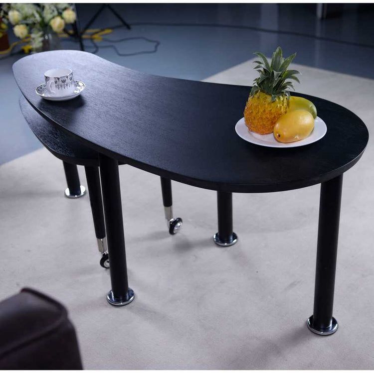 Close-up of 360 Rotatable Coffee Table with tropical fruit, showcasing its smooth black finish and functional dual-tier design.