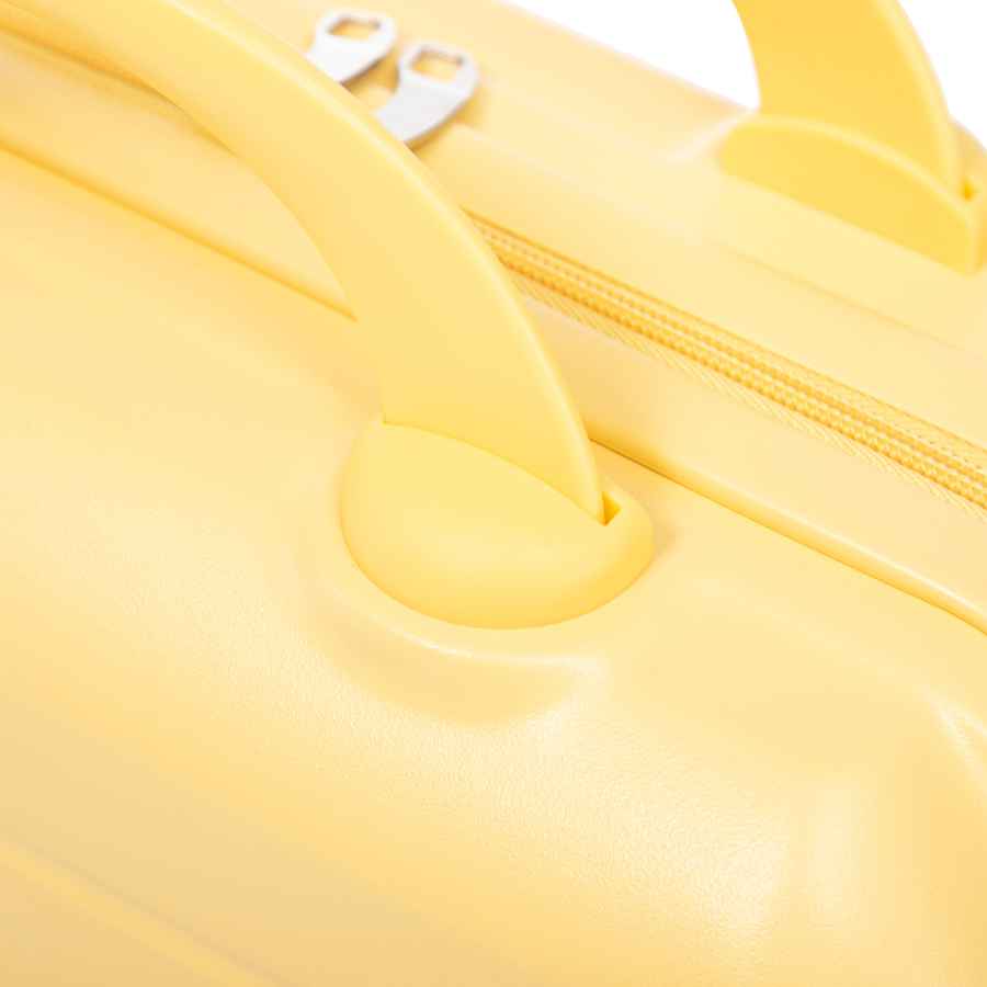 Detailed shot of yellow ABS spinner luggage handle attachment with rounded base and secure fit for easy carrying.