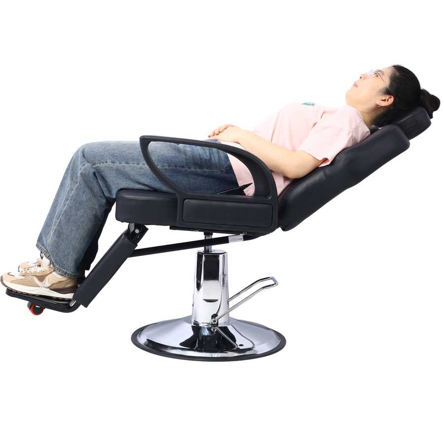 Heavy Duty Hydraulic Barber Chair reclined with adjustable footrest and PU leather upholstery, demonstrating full reclining function for salon use.