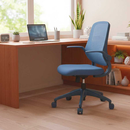 Blue office chair in front of a wooden desk with a laptop and decor items.