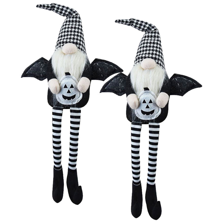 Two Halloween-themed gnomes with bat wings and striped legs on a white background