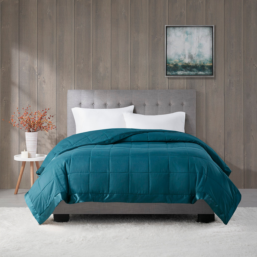 Teal Twin Down Alternative Blanket on bed with satin trim, ideal for cozy, hypoallergenic bedding in stylish home decor.
