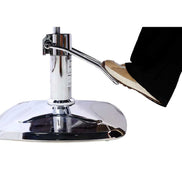 Close-up of foot pedal mechanism on chrome base of salon chair, allowing height adjustment for stylist convenience.