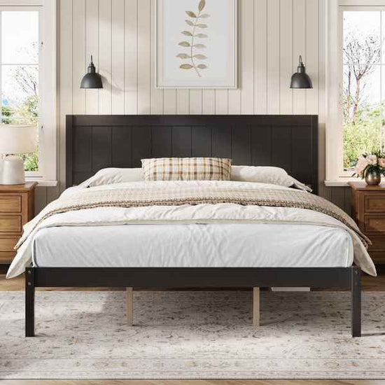 Bedroom with a black bed frame, white bedding, and wooden nightstands.