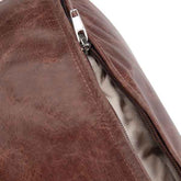 Close-up of a brown leather bag with a zipper on a white background