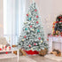 4 ft flocked Christmas tree with pine cones and gifts in a room