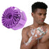 Purple scrubber and a man using it on his arm with soap suds.