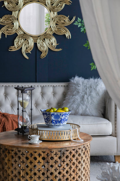 Blue and White Decorative Bowl - Porcelain, Elegant Design used as a centerpiece on a round wooden table in a stylish living room.